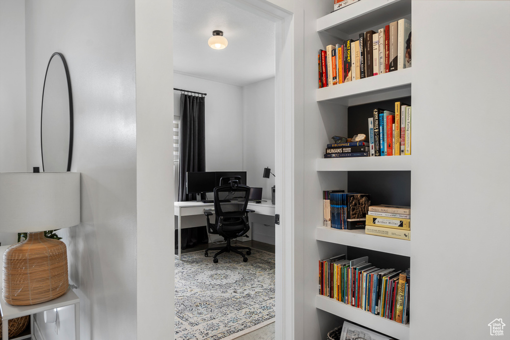 Home office featuring built in shelves