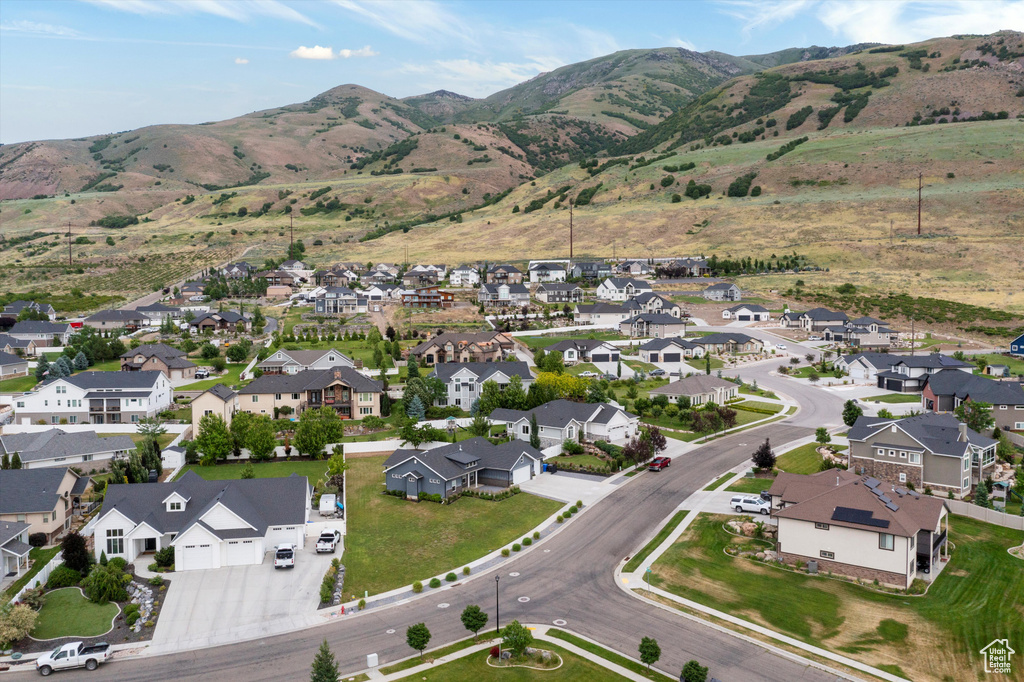 Aerial view of property's location with nearby suburban area and a mountain backdrop
