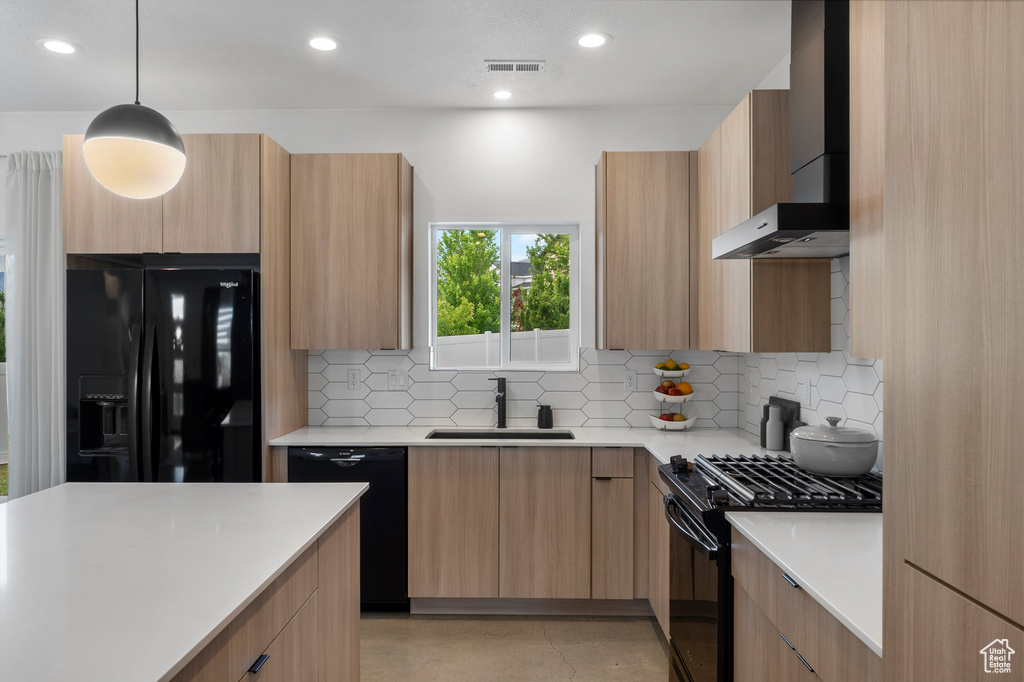 Kitchen with black appliances, modern cabinets, wall chimney exhaust hood, and recessed lighting