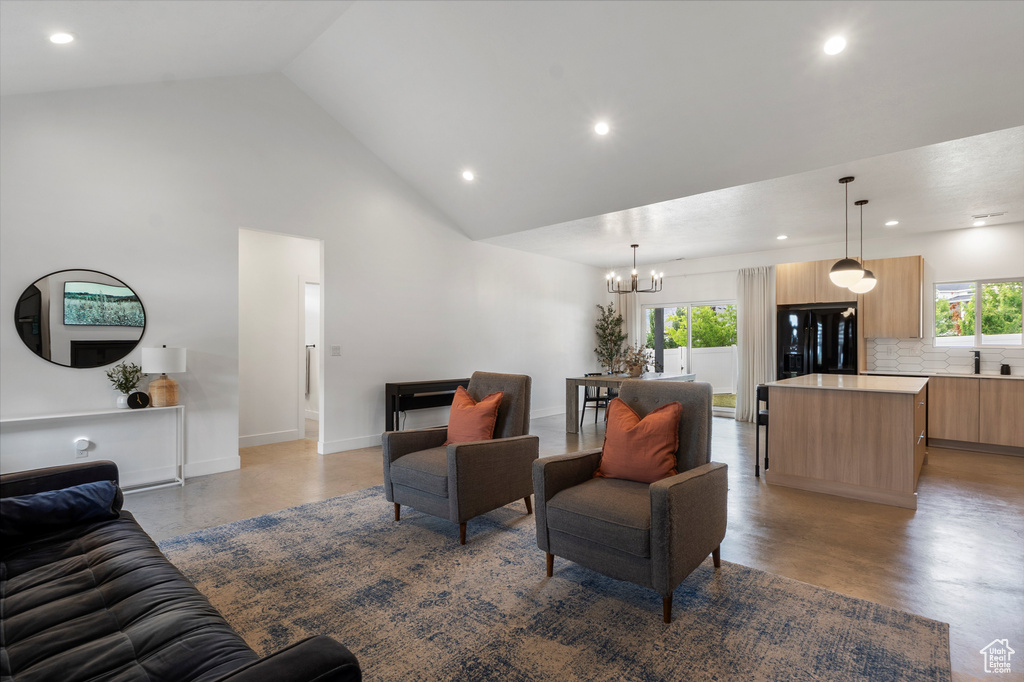 Living room featuring a chandelier, recessed lighting, high vaulted ceiling, and light wood-style floors