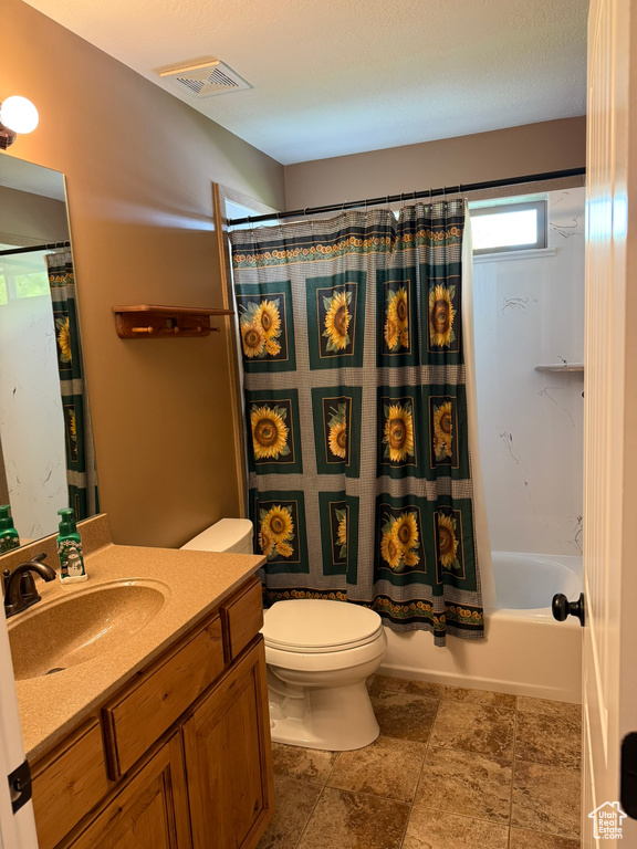 Full bath featuring vanity and shower / bath combo