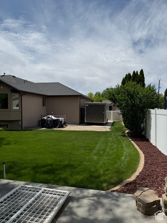 Fenced backyard with a patio
