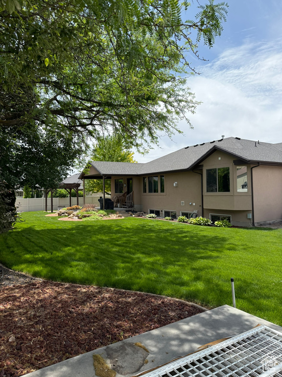Back of property featuring stucco siding