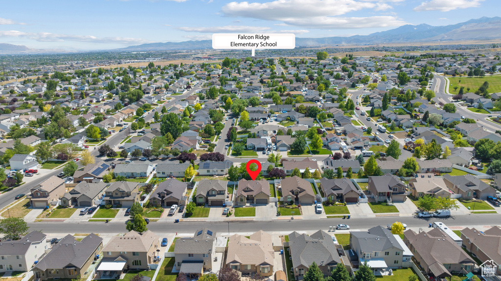 Aerial perspective of suburban area featuring a mountain backdrop