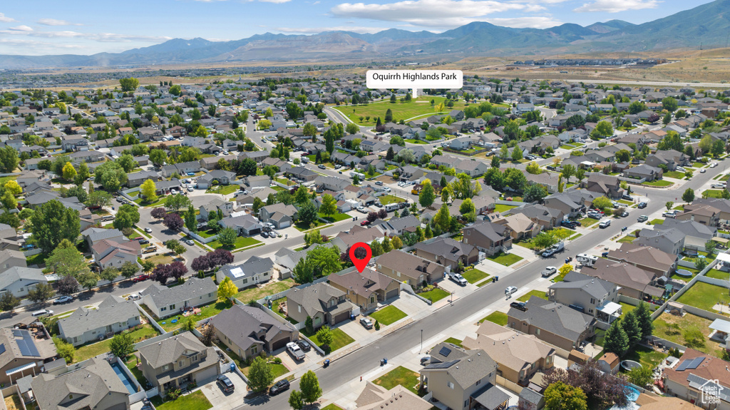 Aerial perspective of suburban area featuring a mountainous background