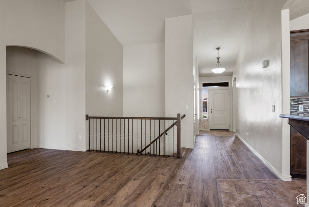 Foyer entrance with wood finished floors and baseboards