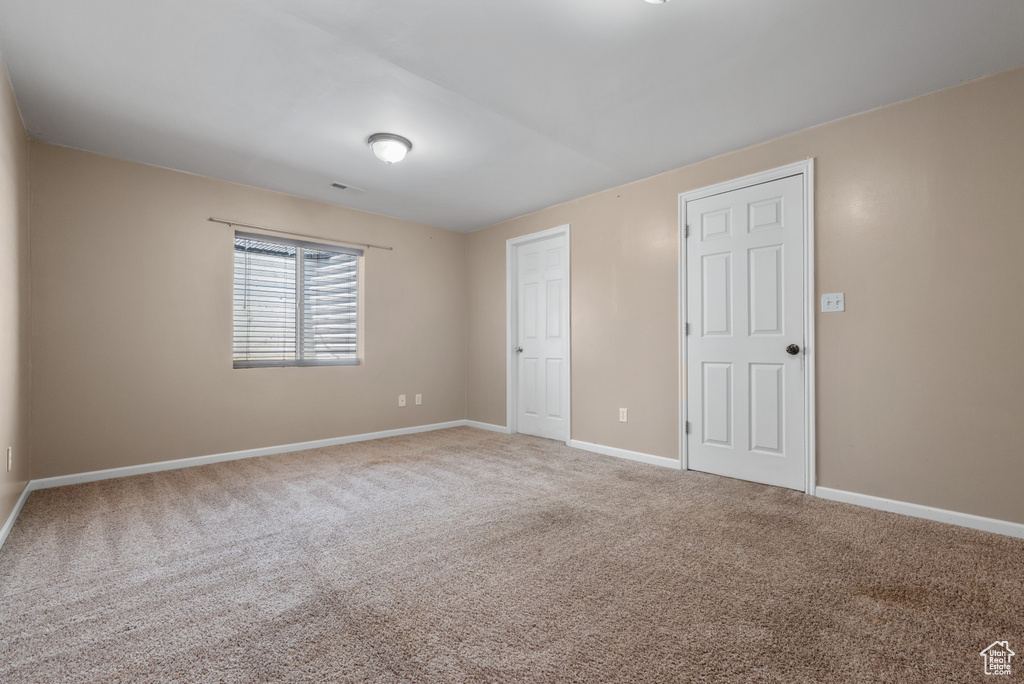 Unfurnished bedroom featuring carpet and baseboards