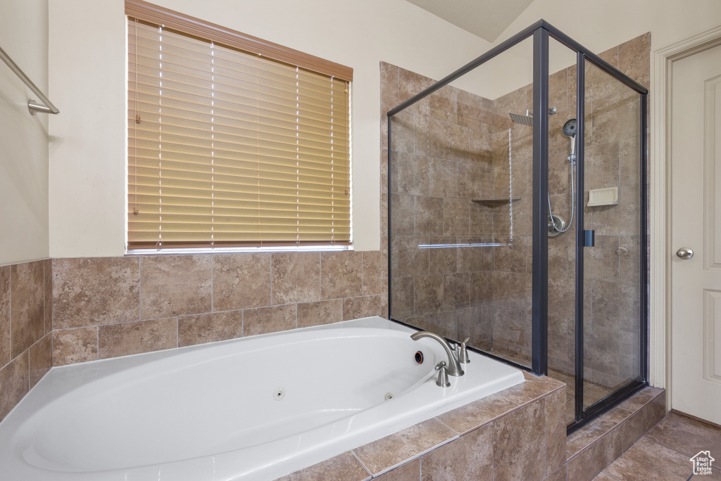 Full bathroom with a jetted tub and a stall shower