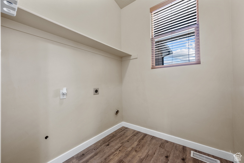 Laundry room with hookup for an electric dryer and wood finished floors