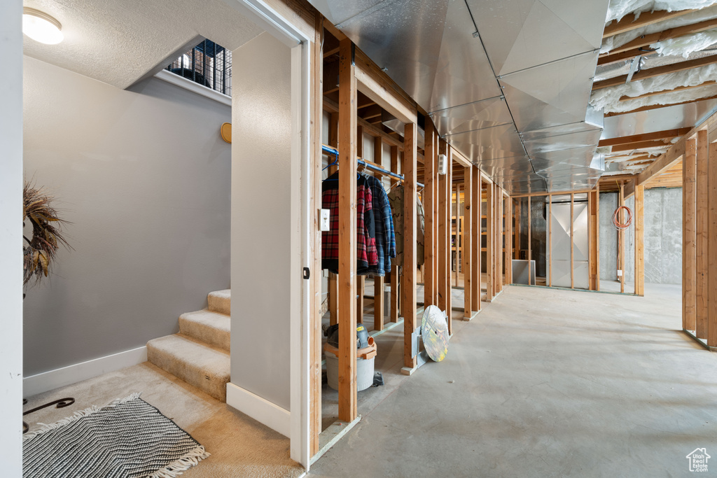 Basement featuring baseboards and stairs