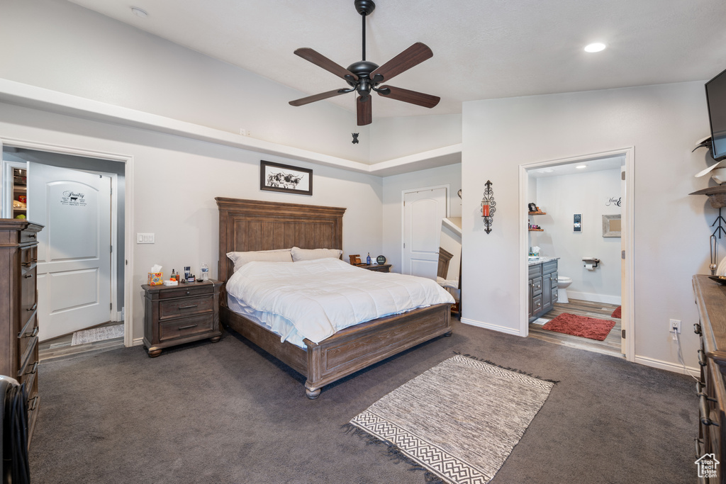Bedroom with dark carpet, recessed lighting, ensuite bathroom, and a ceiling fan