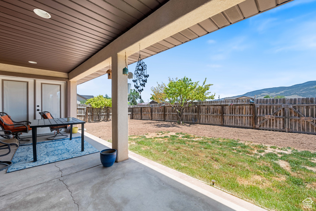 Fenced backyard with a patio and a mountain view