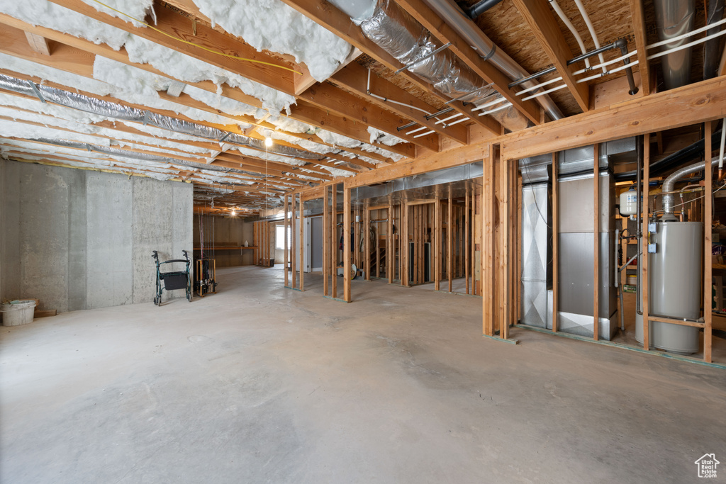 Unfinished basement featuring water heater