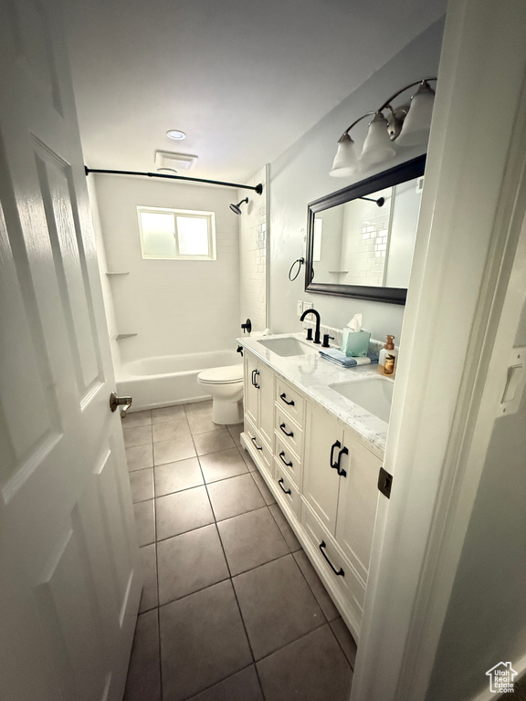 Bathroom with tile patterned floors, double vanity, and shower / bath combination