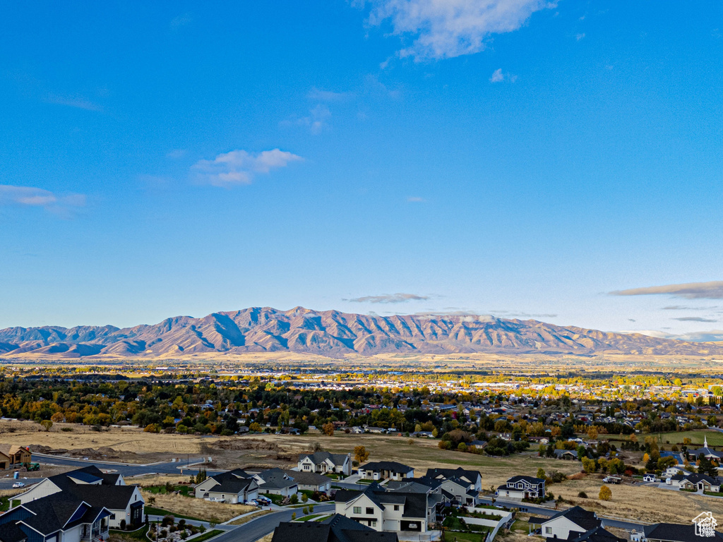 View of mountain backdrop featuring nearby suburban area