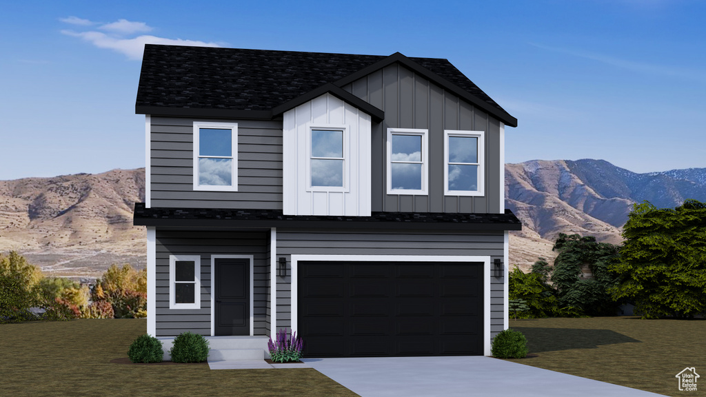 View of front of house with board and batten siding, a mountain view, a garage, and concrete driveway