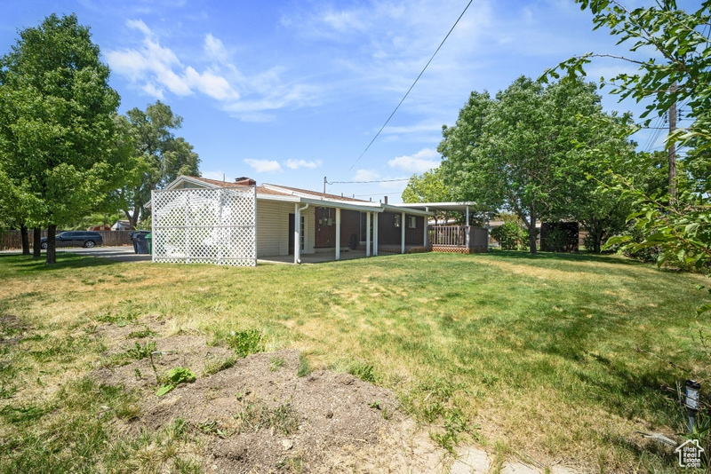 Back of property with a yard and a sunroom