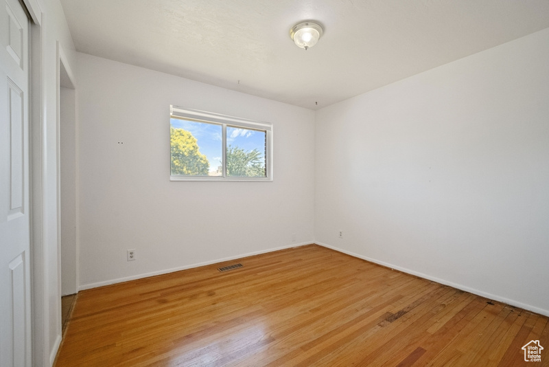 Unfurnished bedroom featuring light wood finished floors and a closet