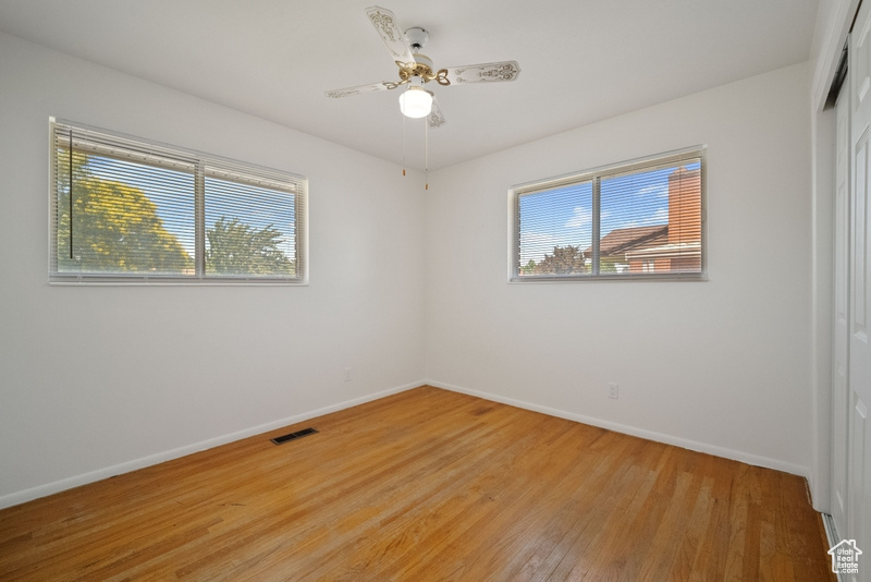 Spare room featuring light wood-type flooring and a ceiling fan