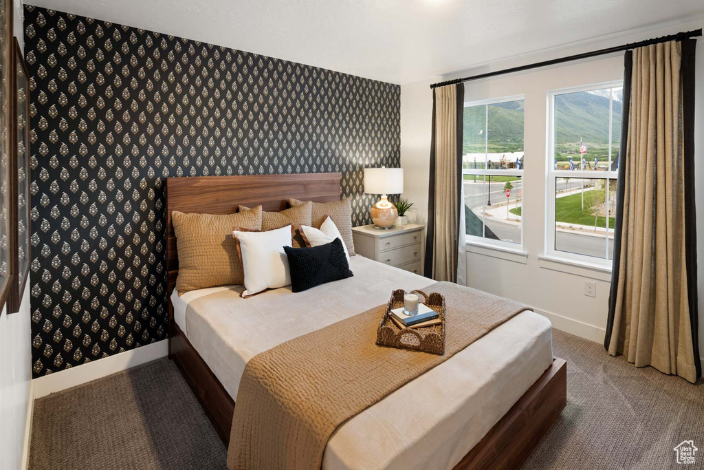 Bedroom featuring carpet floors and wallpapered walls