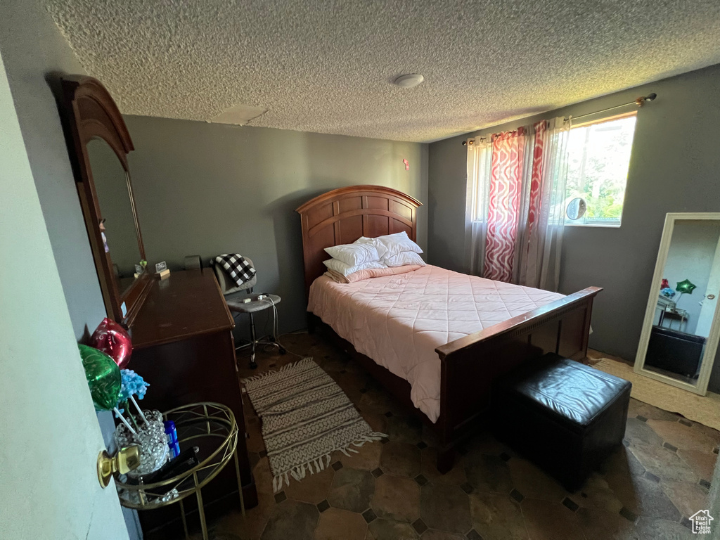 Bedroom featuring a textured ceiling
