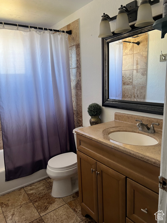 Full bathroom featuring vanity and shower / bathtub combination with curtain