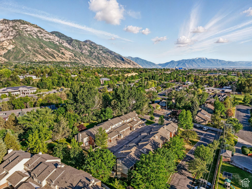 Aerial overview of property\\\'s location featuring a mountainous background and nearby suburban area