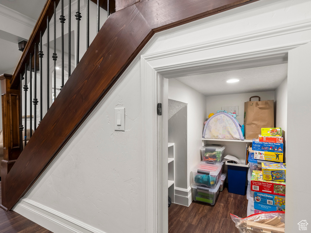 Stairs with wood finished floors and baseboards