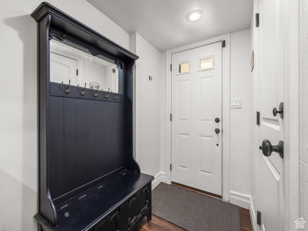 Mudroom featuring dark wood-type flooring and a textured ceiling