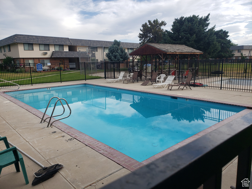 Community pool with a patio and a gazebo