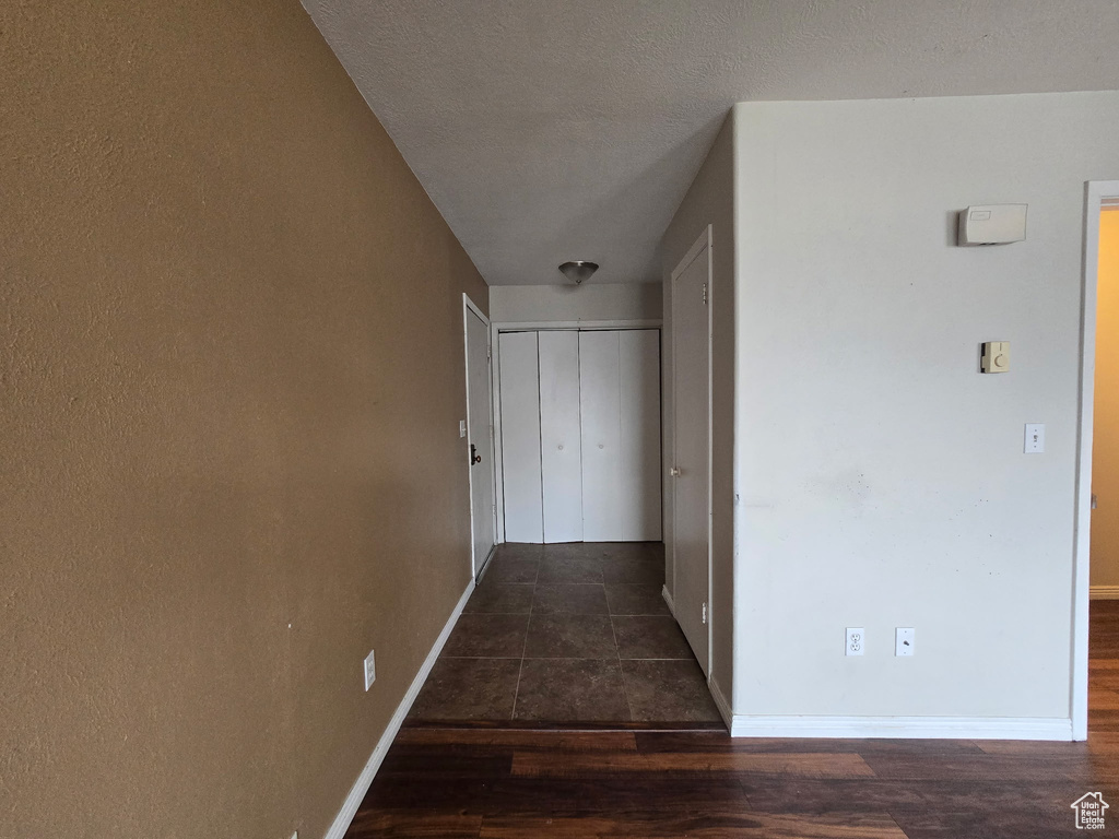 Hallway with wood finished floors and baseboards