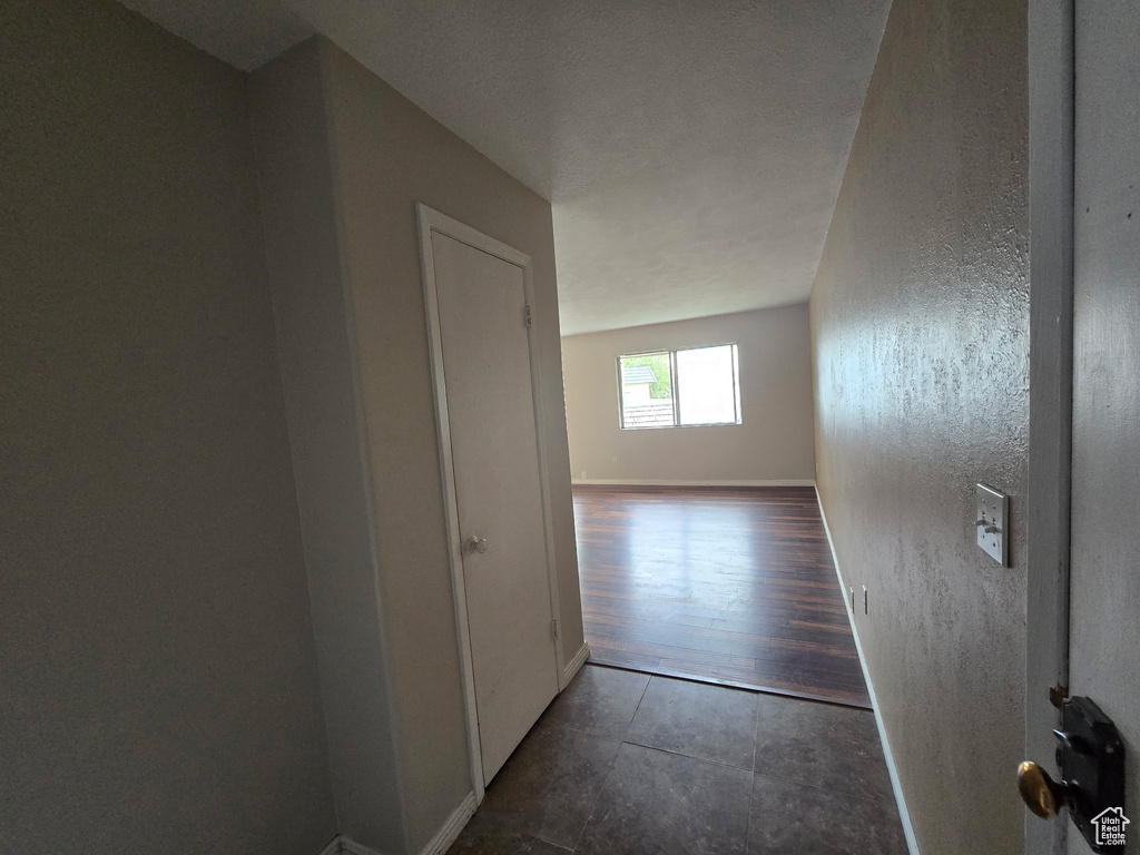 Hall with baseboards and tile patterned floors