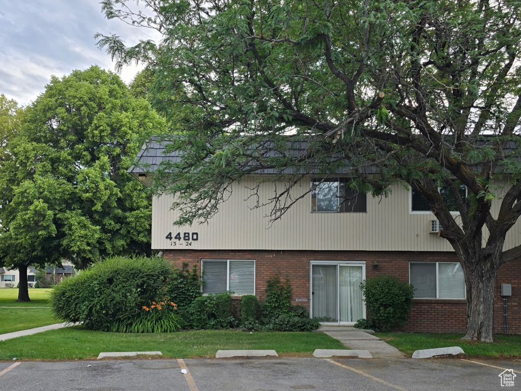 View of property with uncovered parking