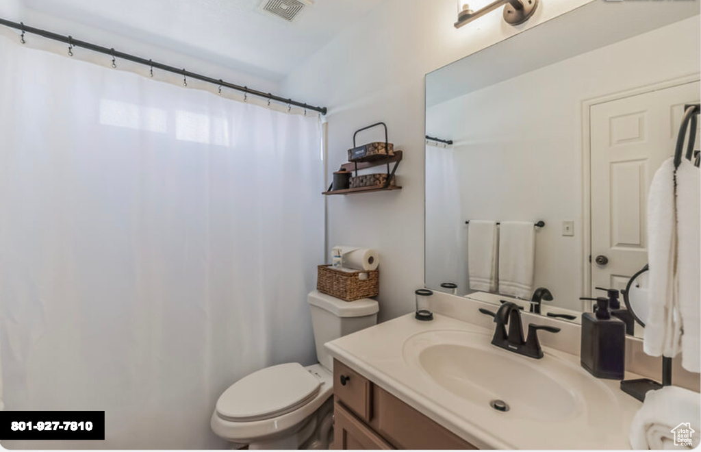 Full bathroom with toilet and vanity