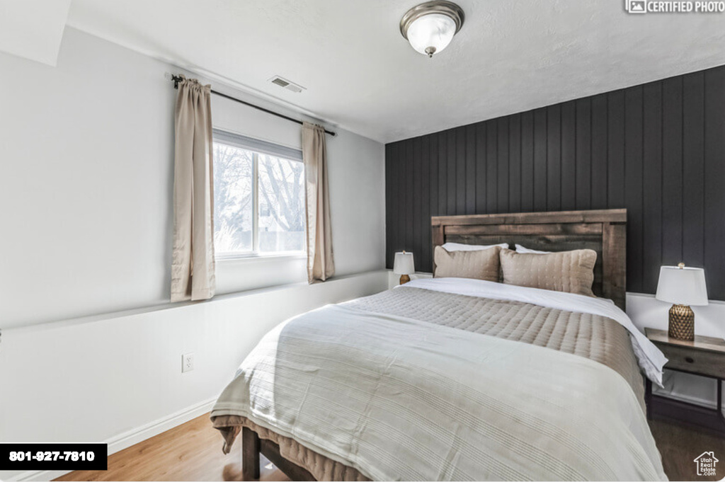 Bedroom featuring wood finished floors and baseboards