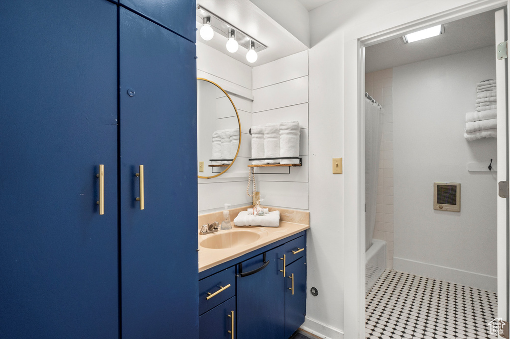 Bathroom with vanity and shower / bath combo with shower curtain