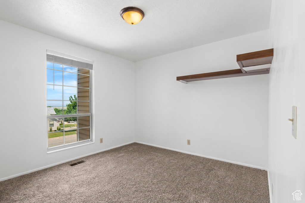 Unfurnished room with carpet floors and baseboards