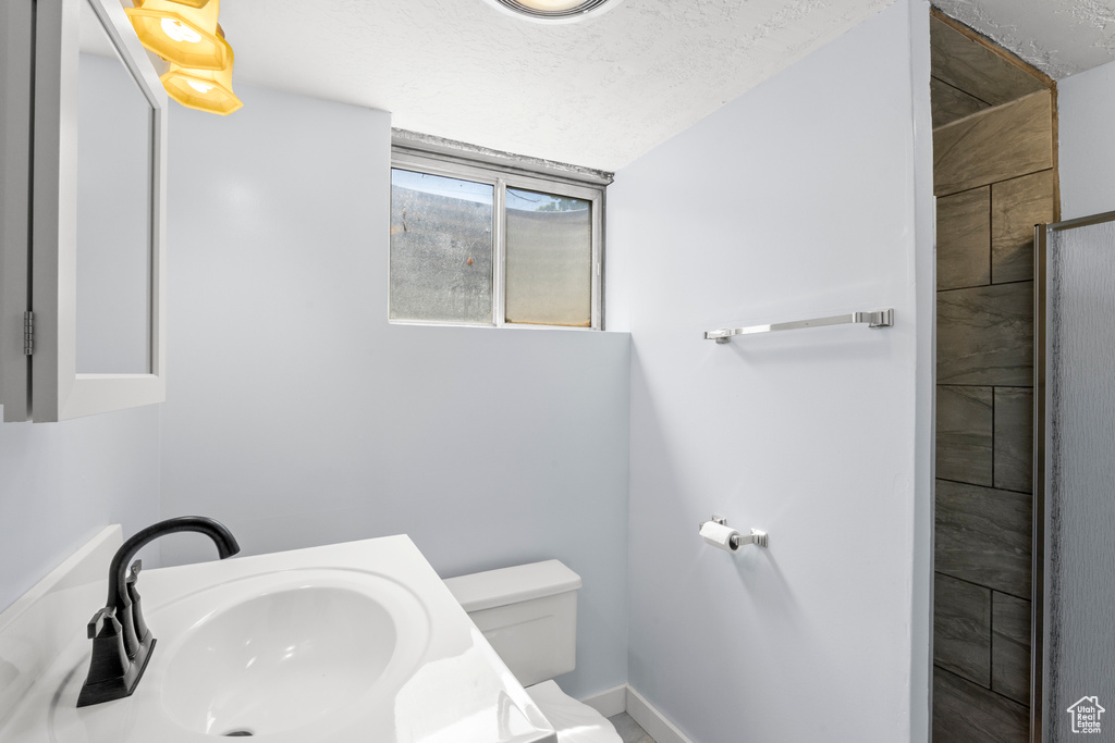 Bathroom featuring a shower and vanity