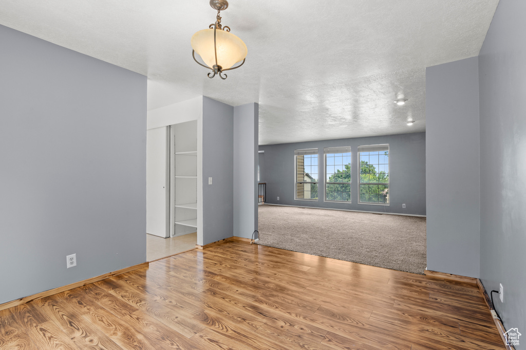Spare room featuring wood finished floors and baseboards