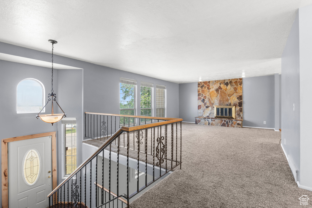 Corridor with an upstairs landing and carpet flooring