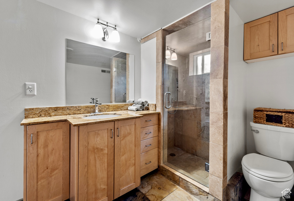 Bathroom with vanity and a shower stall