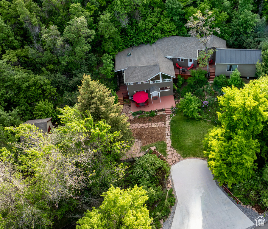 Aerial view of property and surrounding area featuring a heavily wooded area