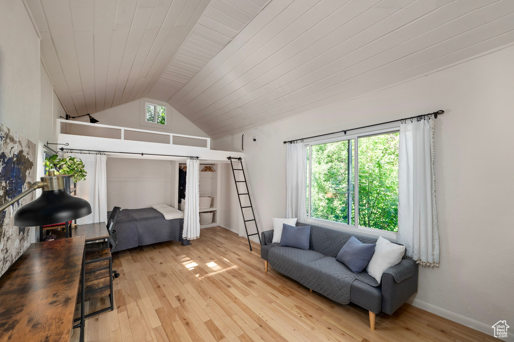 Living area with hardwood / wood-style floors, lofted ceiling, and wooden ceiling