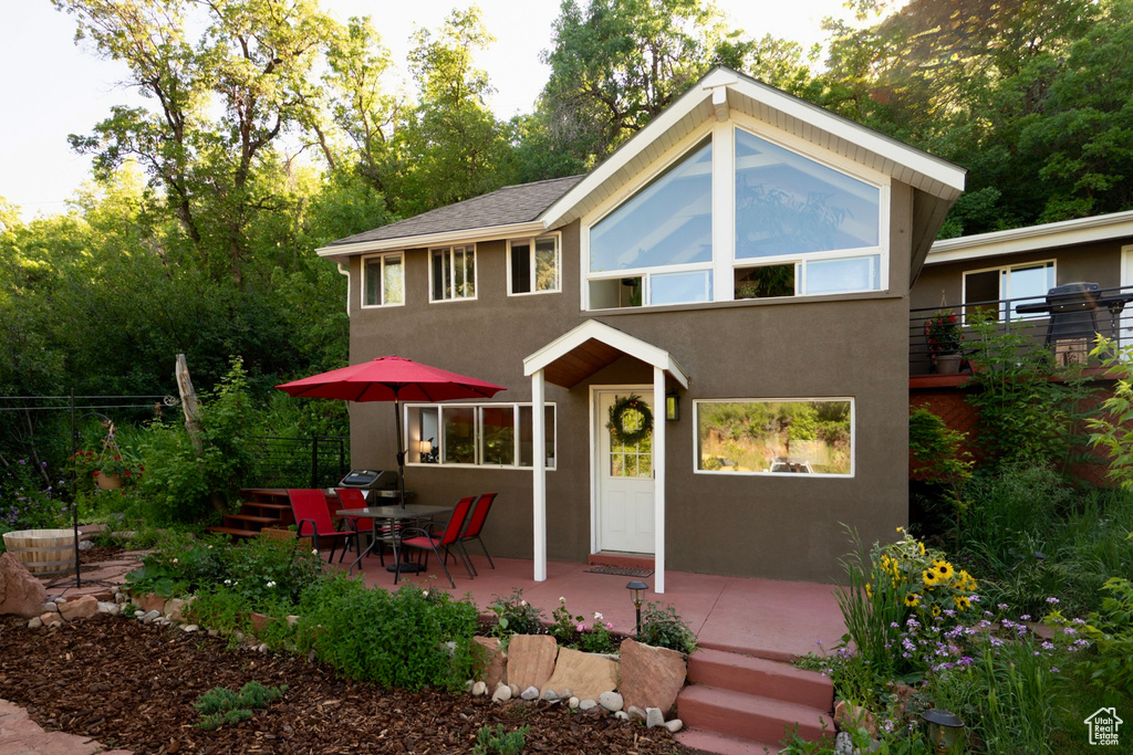 View of front of property featuring stucco siding and a patio