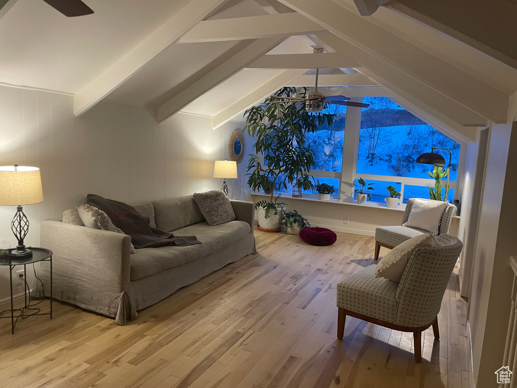 Living area with a ceiling fan and wood finished floors