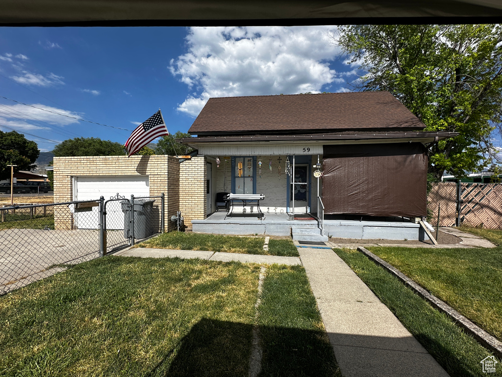 Bungalow with a porch, a gate, and roof with shingles