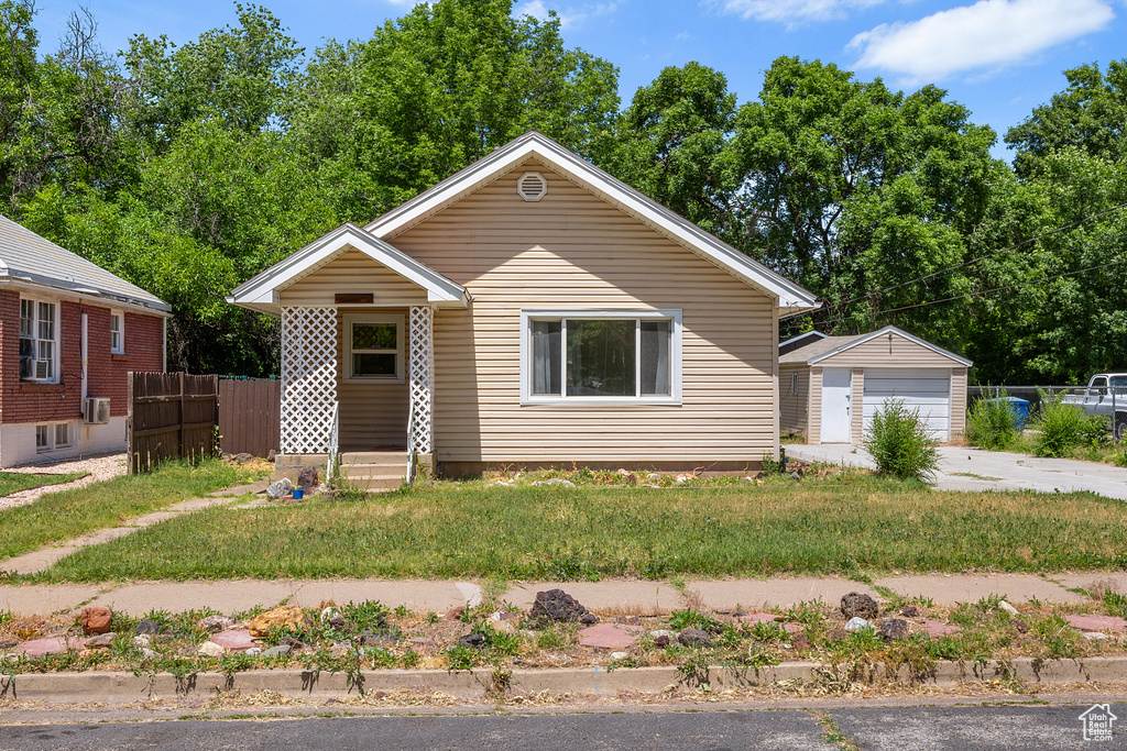 Bungalow-style house with a garage and an outbuilding