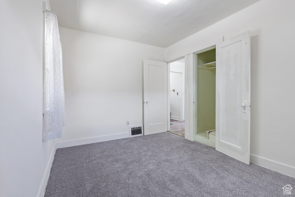 Unfurnished bedroom with carpet and baseboards