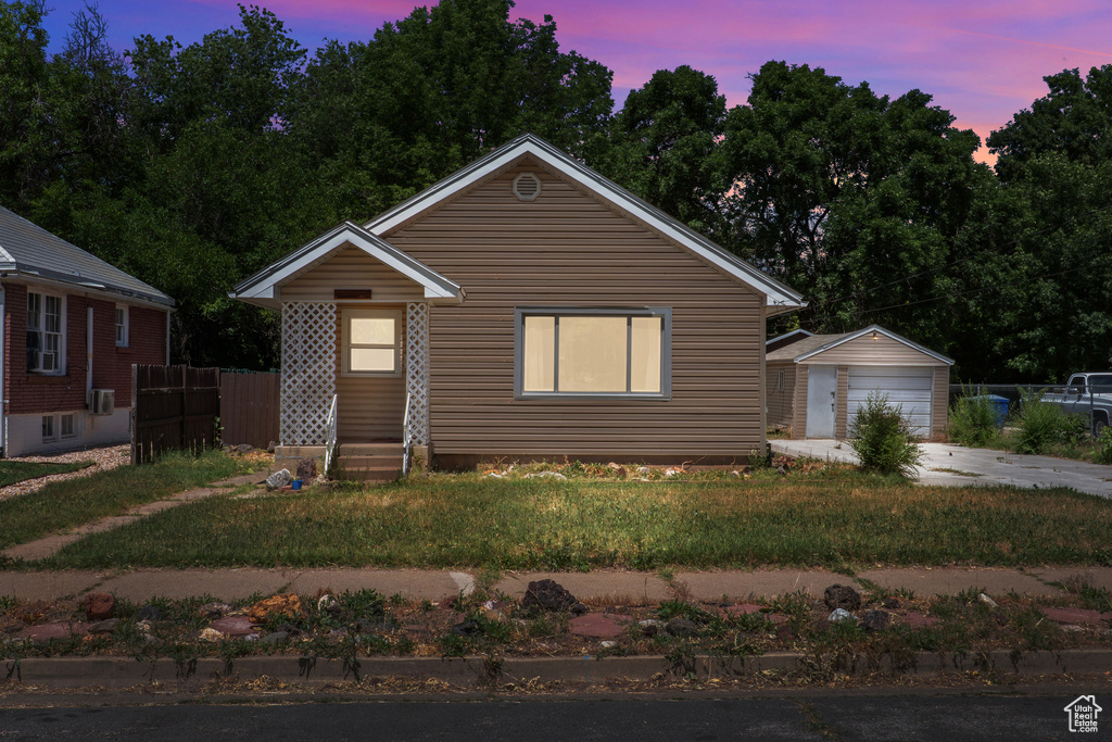 Bungalow-style house with a garage and an outdoor structure