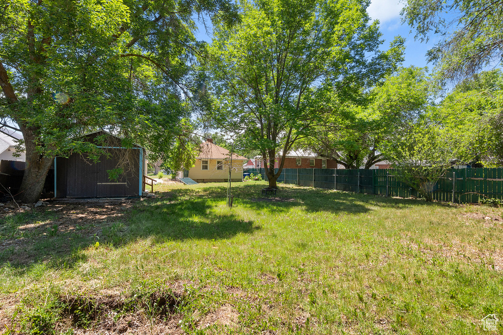 View of yard featuring a storage unit